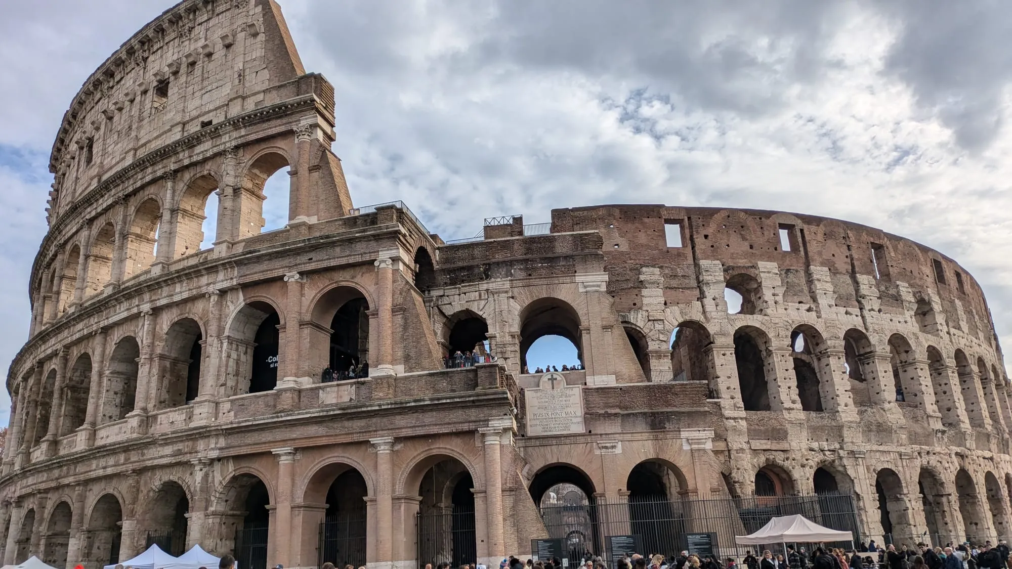 The Colosseum in Rome under a cloudy sky